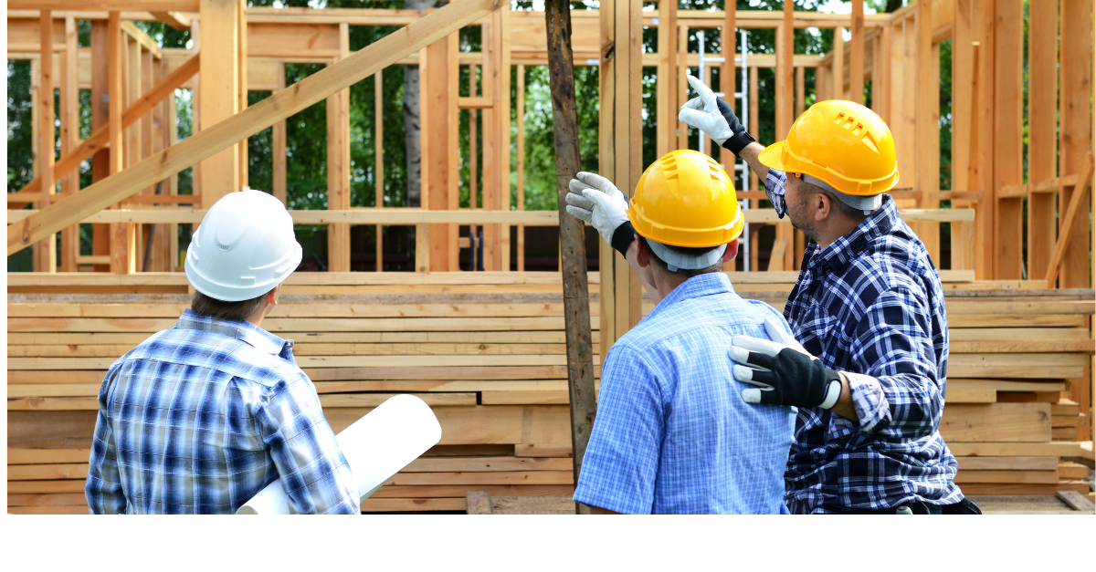 Building contractors are building a house to be sold soon in a new development area.